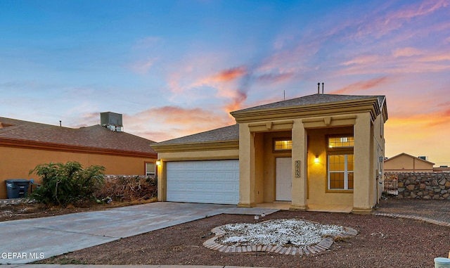 5965 Katelyn Gray Cir, El Paso, TX 79924 - view of front of property with a garage, stucco siding, and driveway