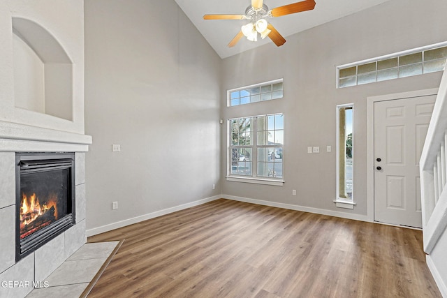 5965 Katelyn Gray Cir, El Paso, TX 79924 - foyer entrance with wood finished floors, high vaulted ceiling, baseboards, a fireplace, and a ceiling fan