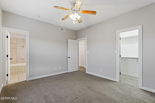 5965 Katelyn Gray Cir, El Paso, TX 79924 - unfurnished bedroom with carpet floors, a spacious closet, baseboards, and ensuite bath