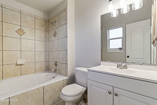 5965 Katelyn Gray Cir, El Paso, TX 79924 - bathroom with vanity, a textured wall, toilet, and tiled shower / bath