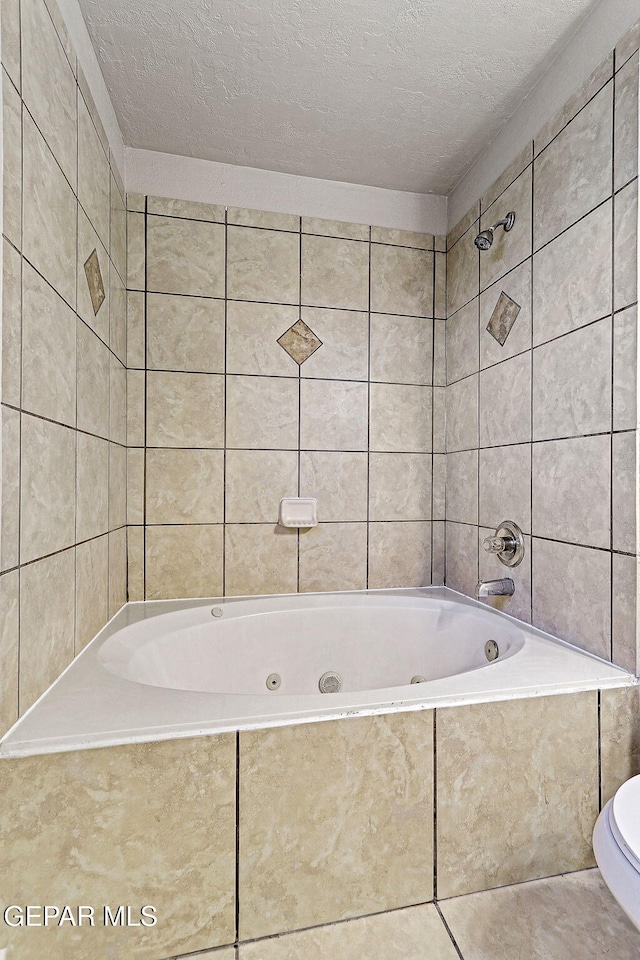 5965 Katelyn Gray Cir, El Paso, TX 79924 - full bathroom with a textured ceiling, toilet, and tile patterned flooring