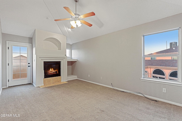 5965 Katelyn Gray Cir, El Paso, TX 79924 - unfurnished living room featuring a tile fireplace, a ceiling fan, carpet flooring, vaulted ceiling, and baseboards