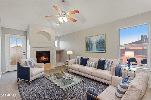 5965 Katelyn Gray Cir, El Paso, TX 79924 - living room featuring a ceiling fan, a fireplace with flush hearth, baseboards, high vaulted ceiling, and carpet flooring