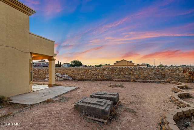 5965 Katelyn Gray Cir, El Paso, TX 79924 - yard at dusk with a fenced backyard and a patio area