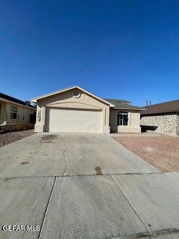 12501 Sombra Fuerte Dr, El Paso, TX 79938 - ranch-style home with driveway, an attached garage, and stucco siding