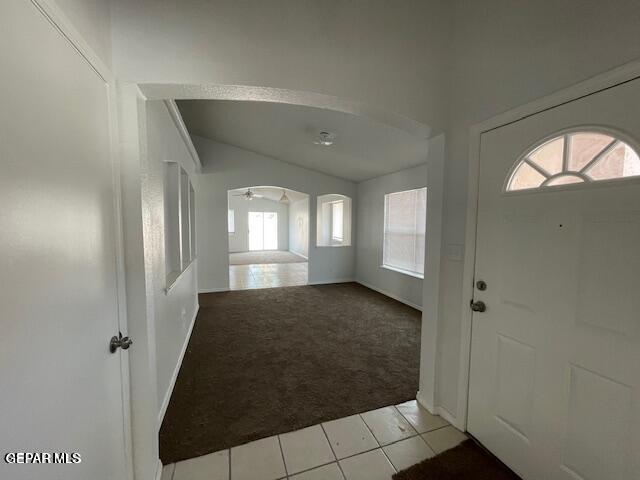 12501 Sombra Fuerte Dr, El Paso, TX 79938 - foyer entrance featuring light colored carpet, healthy amount of natural light, arched walkways, light tile patterned floors, and vaulted ceiling