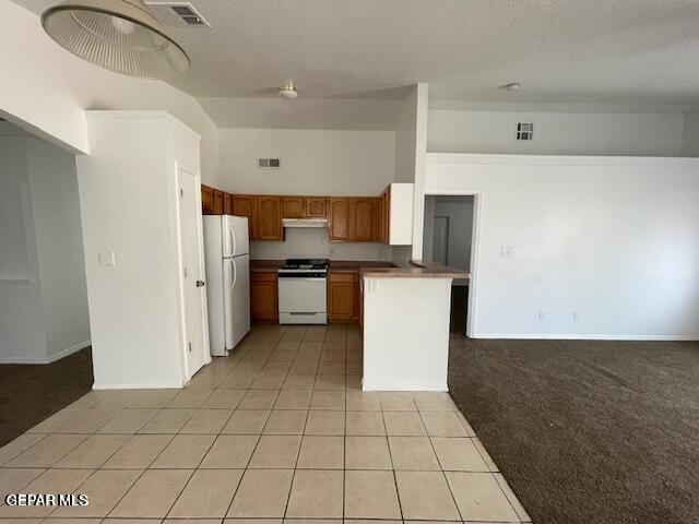 12501 Sombra Fuerte Dr, El Paso, TX 79938 - kitchen with white appliances, light tile patterned floors, brown cabinetry, and baseboards