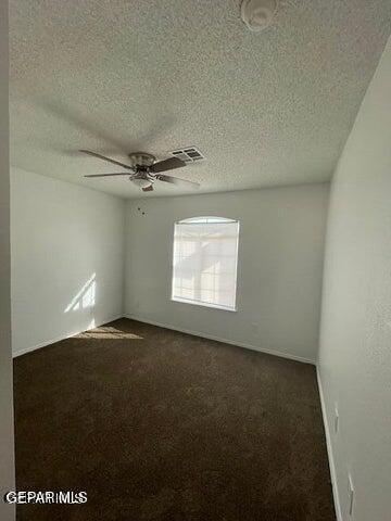 12501 Sombra Fuerte Dr, El Paso, TX 79938 - empty room with ceiling fan, a textured ceiling, and dark colored carpet