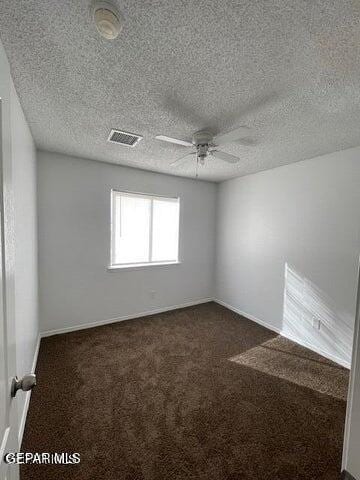 12501 Sombra Fuerte Dr, El Paso, TX 79938 - spare room featuring a ceiling fan, dark colored carpet, a textured ceiling, and baseboards