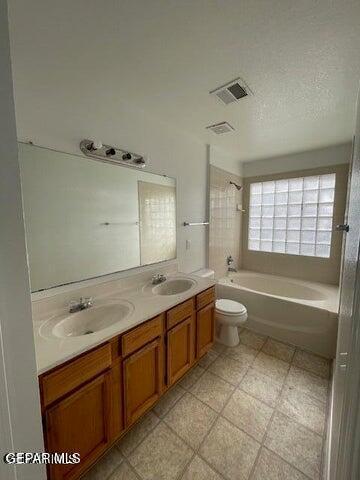 12501 Sombra Fuerte Dr, El Paso, TX 79938 - bathroom featuring double vanity, toilet, and shower / bathtub combination