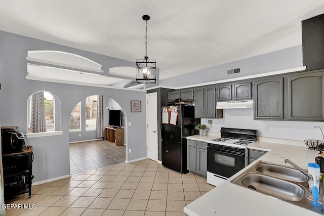 14156 Warren Belin Dr, Horizon City, TX 79928 - kitchen featuring range with gas cooktop, under cabinet range hood, freestanding refrigerator, light countertops, and a sink