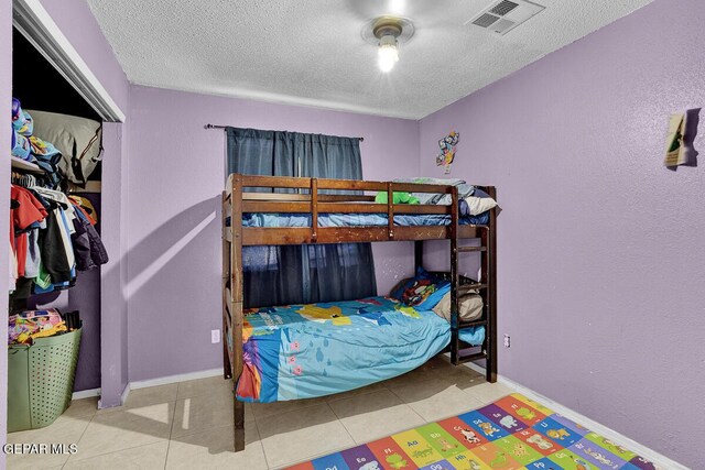 14156 Warren Belin Dr, Horizon City, TX 79928 - tiled bedroom featuring a textured ceiling and baseboards