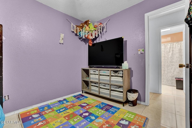 14156 Warren Belin Dr, Horizon City, TX 79928 - recreation room with tile patterned flooring, a textured ceiling, and baseboards
