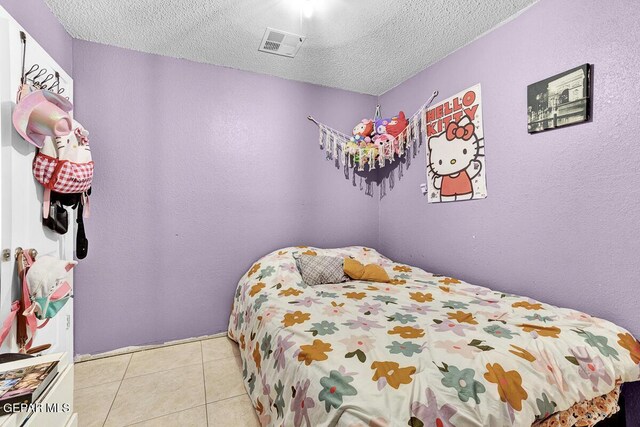 14156 Warren Belin Dr, Horizon City, TX 79928 - bedroom with a textured ceiling and light tile patterned flooring