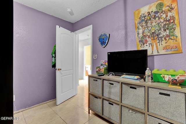 14156 Warren Belin Dr, Horizon City, TX 79928 - bedroom featuring light tile patterned floors, a textured ceiling, a textured wall, and baseboards