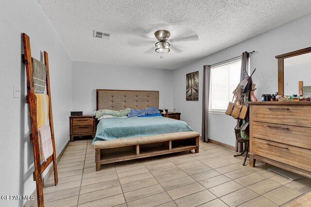 14156 Warren Belin Dr, Horizon City, TX 79928 - bedroom featuring light tile patterned flooring, a textured ceiling, ceiling fan, and baseboards