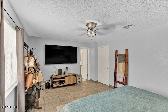14156 Warren Belin Dr, Horizon City, TX 79928 - tiled bedroom with a textured ceiling and a ceiling fan