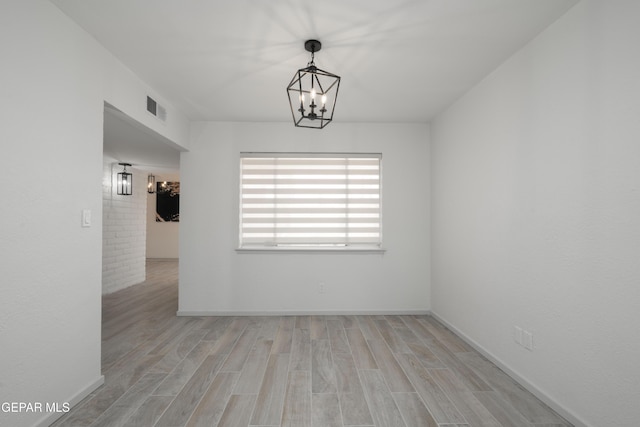 6608 Los Altos Dr, El Paso, TX 79912 - empty room featuring light wood-style floors, a chandelier, and baseboards