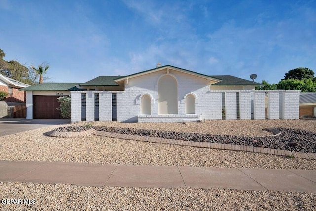 6608 Los Altos Dr, El Paso, TX 79912 - view of front of house featuring an attached garage and concrete driveway