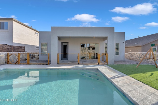 2174 Enchanted Crest Dr, El Paso, TX 79911 - rear view of house featuring an outdoor pool and stucco siding