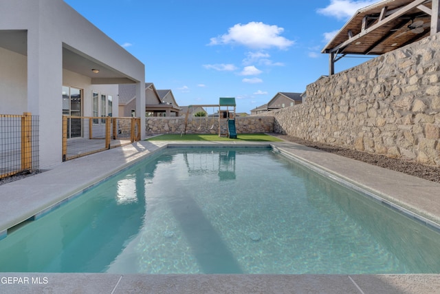 2174 Enchanted Crest Dr, El Paso, TX 79911 - view of pool with a playground and a fenced backyard