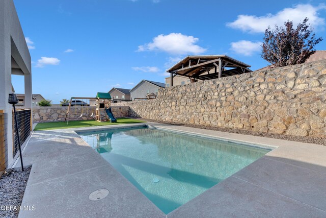 2174 Enchanted Crest Dr, El Paso, TX 79911 - view of pool featuring a fenced backyard, a playground, and a patio