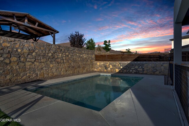 2174 Enchanted Crest Dr, El Paso, TX 79911 - pool at dusk with a fenced backyard and a patio area