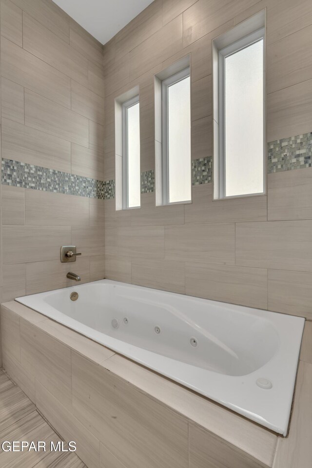 2174 Enchanted Crest Dr, El Paso, TX 79911 - bathroom with a tub with jets and tile walls