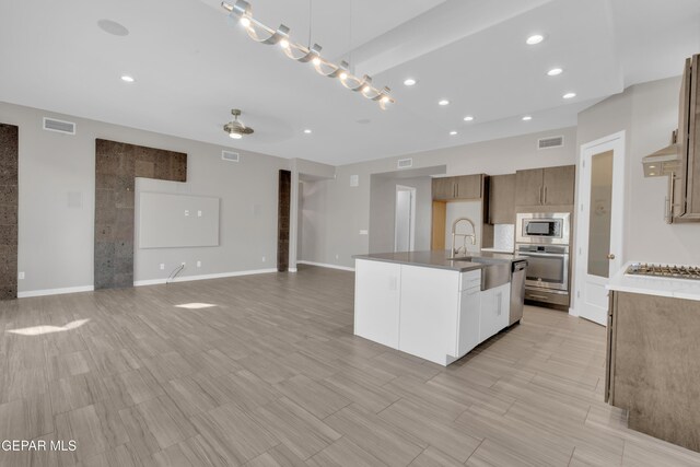2174 Enchanted Crest Dr, El Paso, TX 79911 - kitchen with appliances with stainless steel finishes, recessed lighting, open floor plan, an island with sink, and a sink