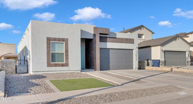 2174 Enchanted Crest Dr, El Paso, TX 79911 - modern home with a garage, concrete driveway, a gate, and stucco siding