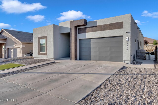 2174 Enchanted Crest Dr, El Paso, TX 79911 - modern home featuring an attached garage, driveway, and stucco siding