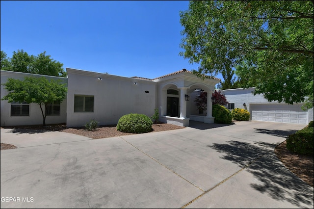 4490 Shadow Willow Dr, El Paso, TX 79922 - mediterranean / spanish-style home with concrete driveway, stucco siding, a tiled roof, and a garage