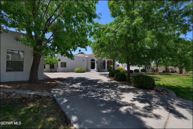 4490 Shadow Willow Dr, El Paso, TX 79922 - view of front of house with curved driveway, stucco siding, a front yard, and a tile roof