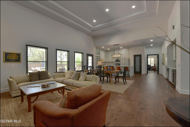 4490 Shadow Willow Dr, El Paso, TX 79922 - living area with a towering ceiling, light wood-style floors, recessed lighting, baseboards, and a tray ceiling