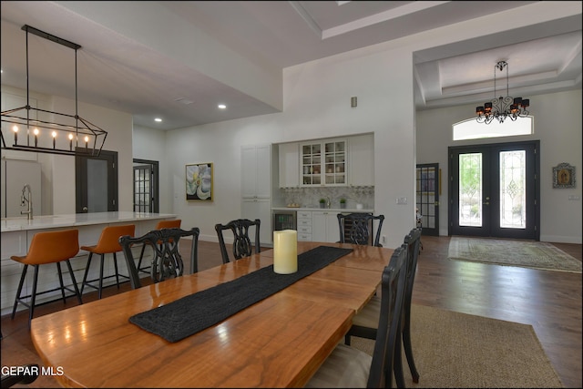 4490 Shadow Willow Dr, El Paso, TX 79922 - dining area with a chandelier, wood finished floors, a towering ceiling, beverage cooler, and french doors