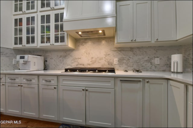 4490 Shadow Willow Dr, El Paso, TX 79922 - kitchen with stainless steel gas stovetop, light countertops, tasteful backsplash, and premium range hood
