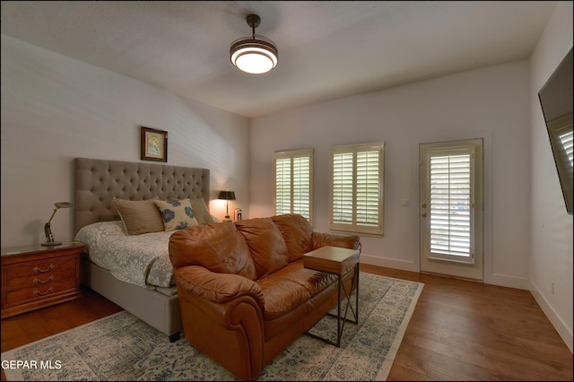 4490 Shadow Willow Dr, El Paso, TX 79922 - bedroom with multiple windows, wood finished floors, and baseboards