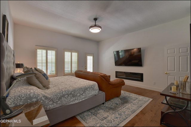4490 Shadow Willow Dr, El Paso, TX 79922 - bedroom with baseboards and dark wood-style floors