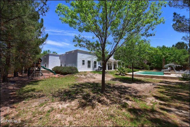 4490 Shadow Willow Dr, El Paso, TX 79922 - view of yard with a playground, an outdoor pool, and a patio area
