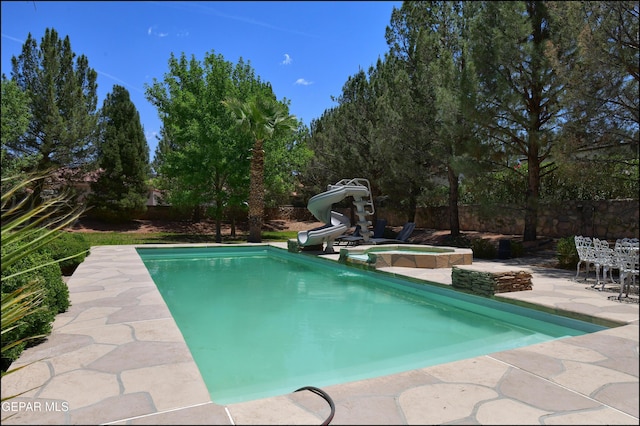 4490 Shadow Willow Dr, El Paso, TX 79922 - view of swimming pool with a patio, a water slide, a fenced backyard, and a pool with connected hot tub