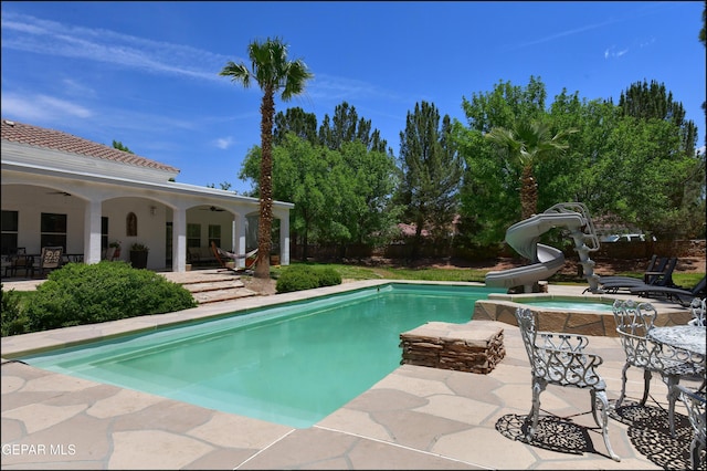 4490 Shadow Willow Dr, El Paso, TX 79922 - outdoor pool with a water slide, ceiling fan, a patio area, and a jacuzzi