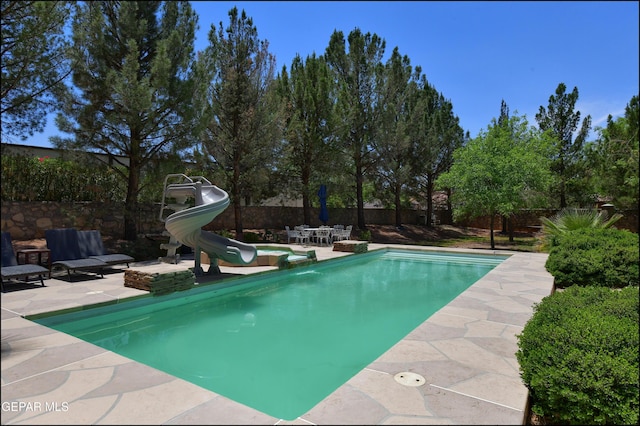 4490 Shadow Willow Dr, El Paso, TX 79922 - view of swimming pool with a water slide and a patio area