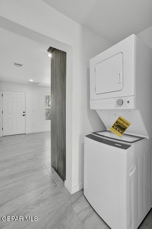 1107 Myrtle Ave A-D, Unit A-D, El Paso, TX 79901 - laundry area with stacked washer and clothes dryer and baseboards