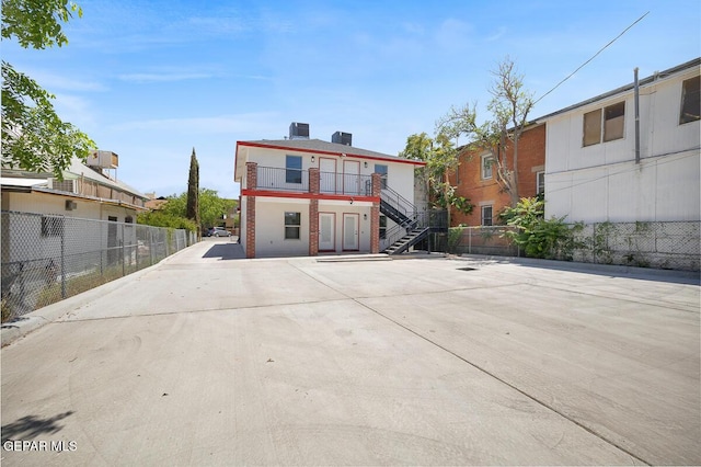 1107 Myrtle Ave A-D, Unit A-D, El Paso, TX 79901 - view of front of house featuring stairway, brick siding, and a balcony