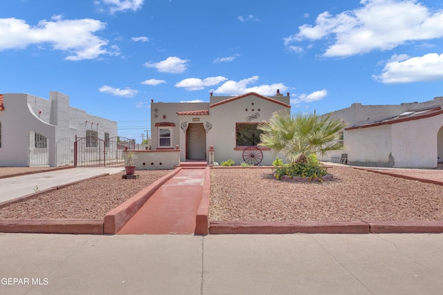 2312 Grant Ave, El Paso, TX 79930 - mediterranean / spanish house with a gate and stucco siding
