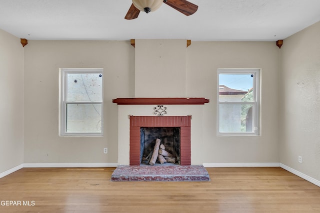 2312 Grant Ave, El Paso, TX 79930 - living area with wood finished floors, a brick fireplace, baseboards, and a ceiling fan