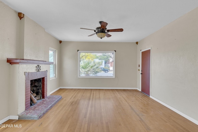 2312 Grant Ave, El Paso, TX 79930 - unfurnished living room with a brick fireplace, a ceiling fan, wood finished floors, and baseboards