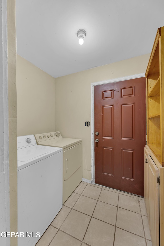 2312 Grant Ave, El Paso, TX 79930 - laundry area featuring separate washer and dryer, light tile patterned flooring, baseboards, and cabinet space
