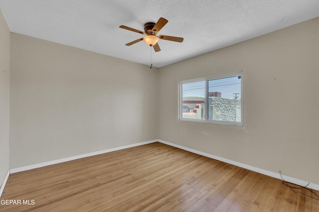 2312 Grant Ave, El Paso, TX 79930 - spare room with light wood finished floors, baseboards, ceiling fan, and a textured ceiling