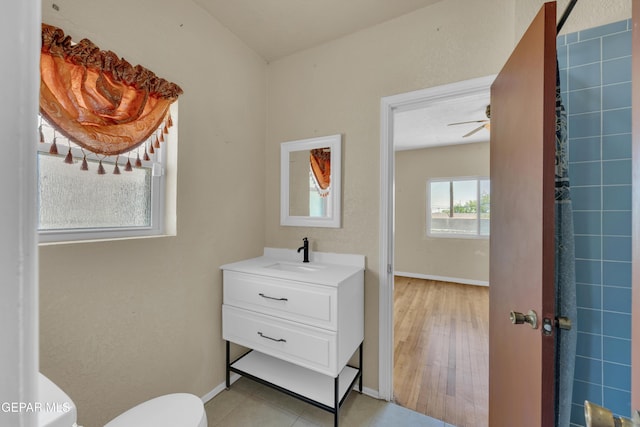 2312 Grant Ave, El Paso, TX 79930 - bathroom featuring toilet, vanity, baseboards, and ceiling fan